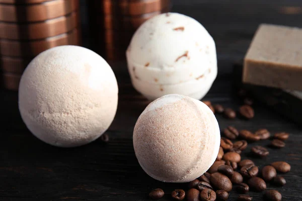 Bath bombs and coffee beans on black wooden table