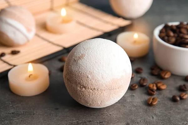 Bath bomb, coffee beans and candles on table, closeup