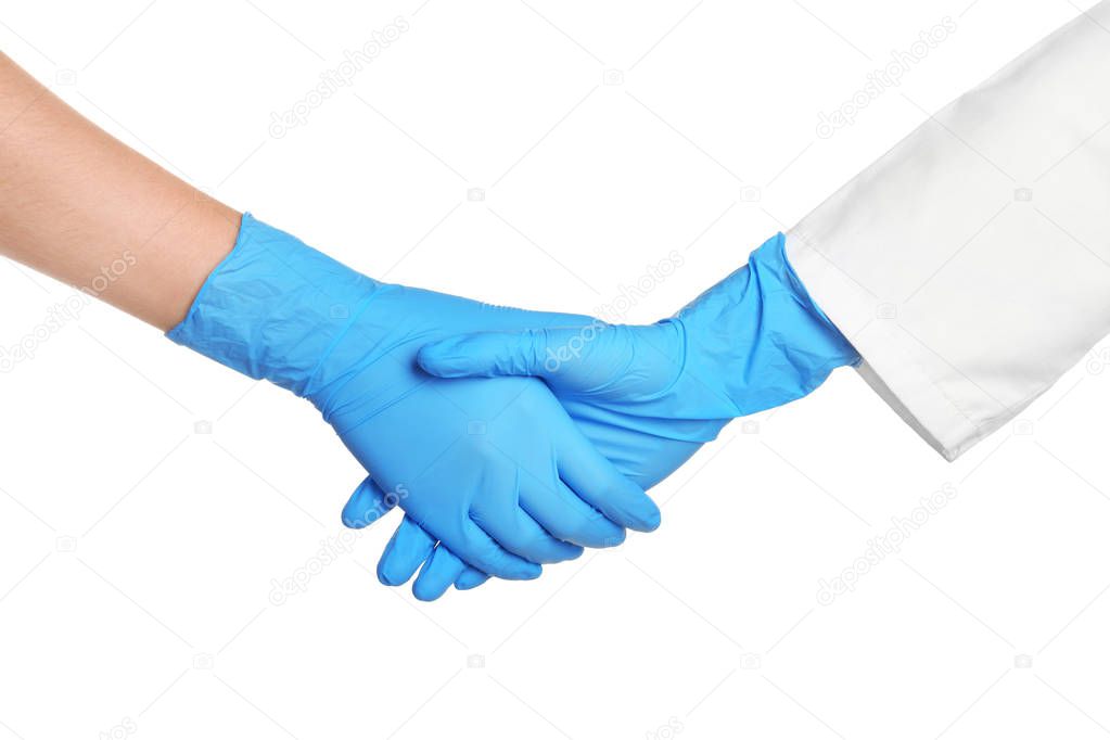 Doctors shacking hands in medical gloves on white background