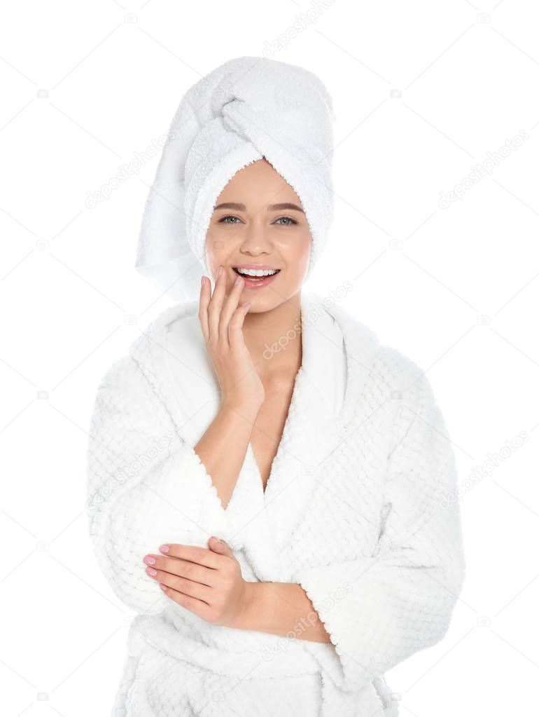 Portrait of young pretty woman in bathrobe with towel on white background