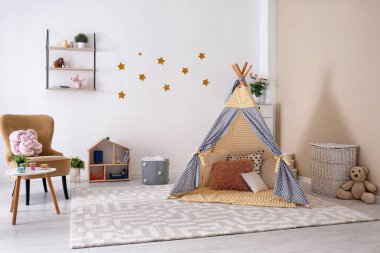 Cozy kids room interior with play tent and toys clipart