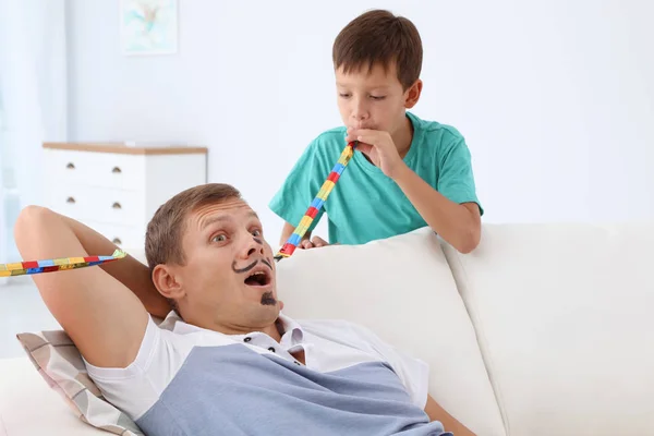 Little Boy Waking His Father Party Blower Home April Fool — Stock Photo, Image