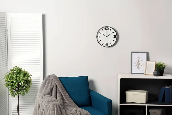 Room interior with clock on wall. Time management