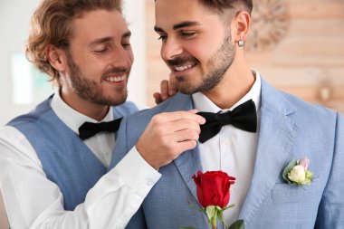 Evde çiçek ile mutlu yeni evli gay çift