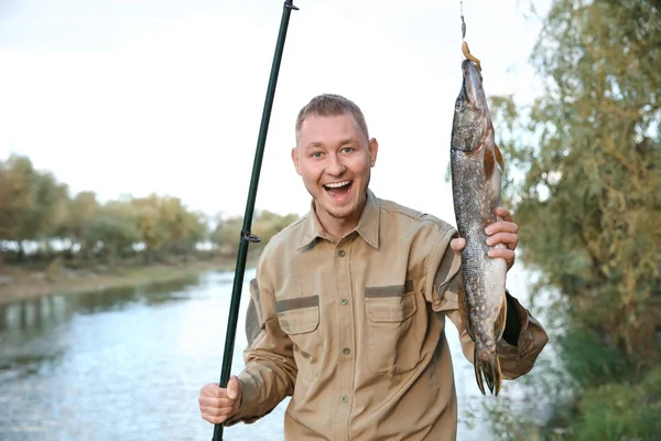 Man Rod Catch Fishing Riverside Recreational Activity Stock Photo by  ©NewAfrica 226640870