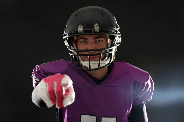 American football player wearing uniform on dark background