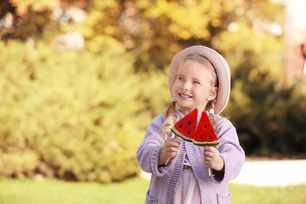 Cute Little Girl Tasty Candies Outdoors — Stock Photo, Image