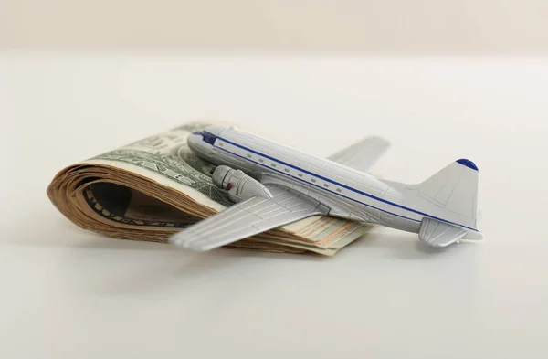 Toy plane and money on white background. Travel insurance
