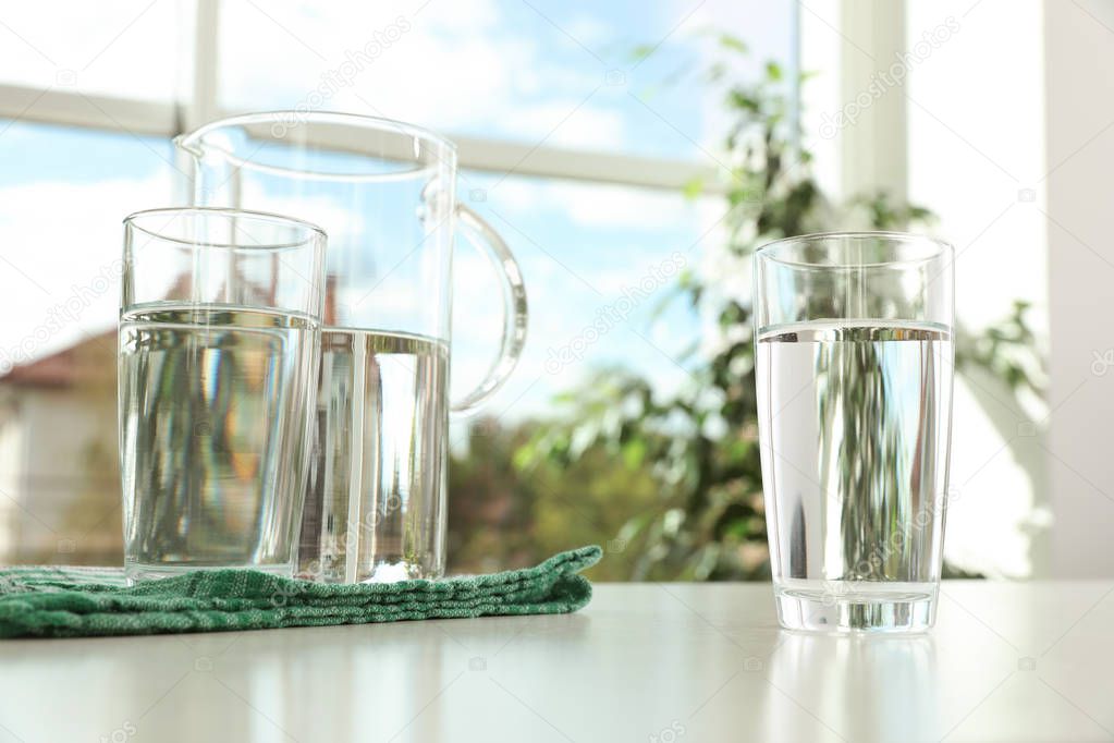 Glassware of fresh water on table indoors
