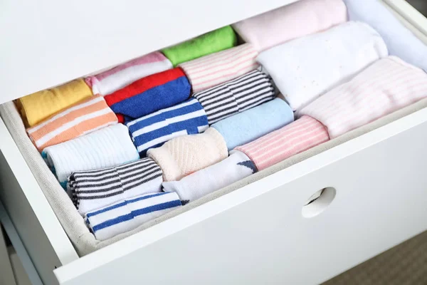 Wardrobe drawer with many child socks, closeup