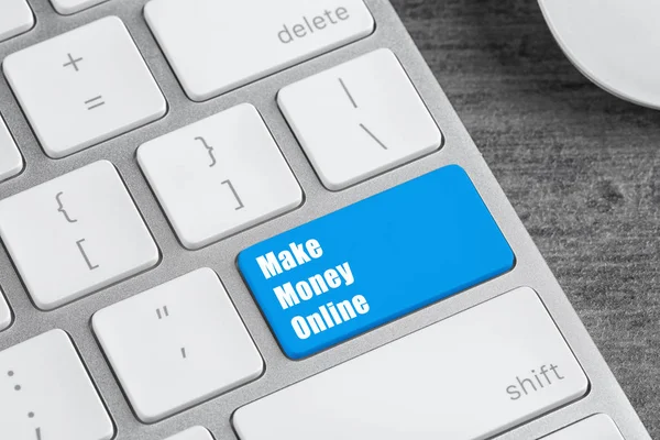 Computer keyboard with MAKE MONEY ONLINE button, closeup view