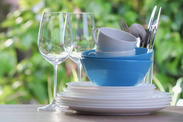 Clean Dishes Cups Shiny Cutlery Glasses Wooden Table Blurred Background — Stock Photo, Image