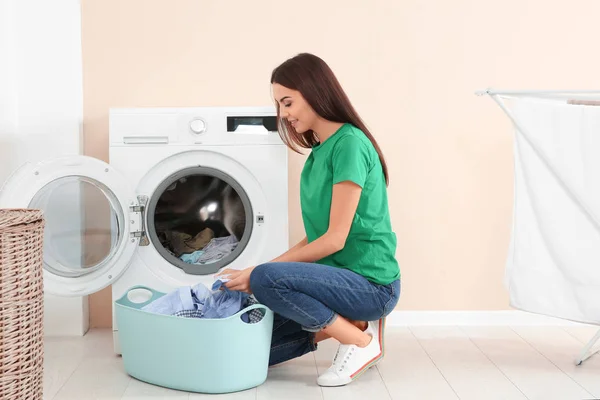 Young Woman Taking Laundry Out Washing Machine Home — Stock Photo, Image