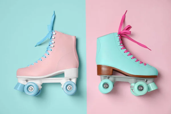 Vintage roller skates on color background, top view