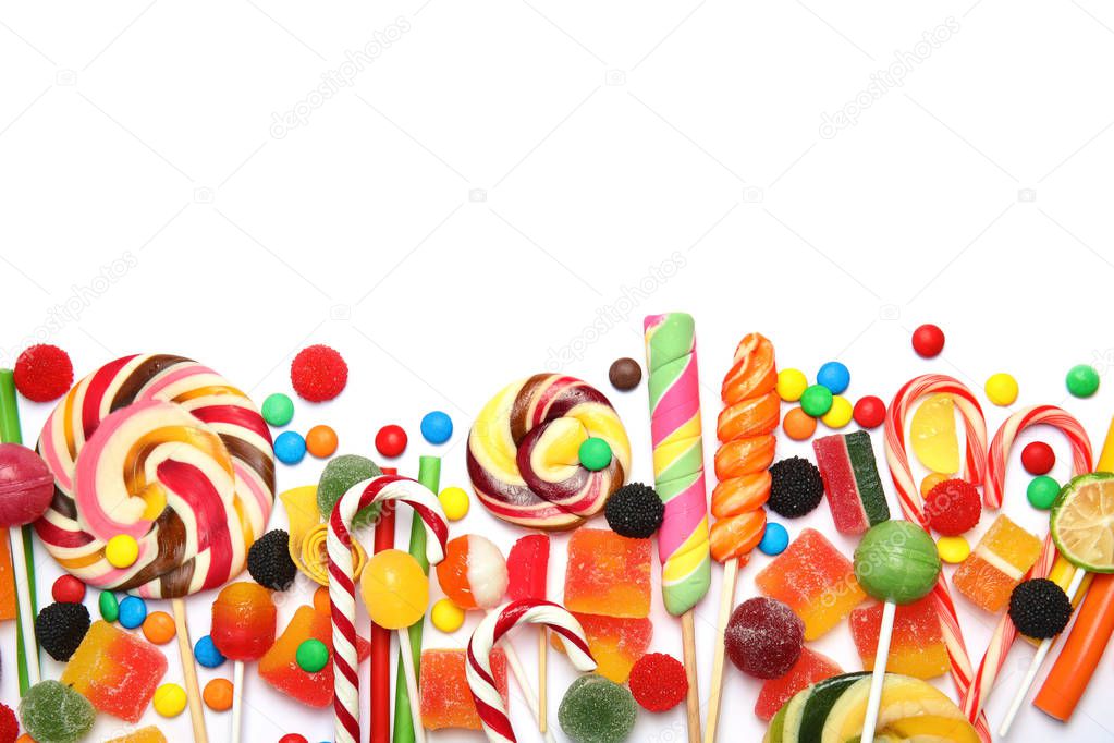 Many different yummy candies on white background, top view. Space for text