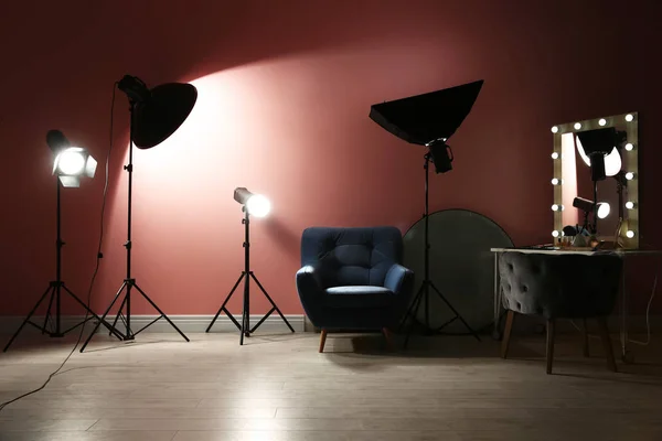 Different professional lighting equipment in modern photo studio