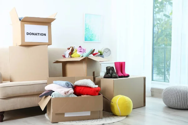 Carton boxes with donations in living room