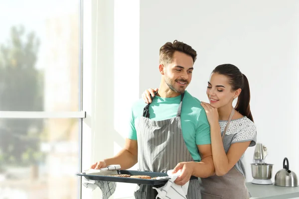 Young Couple Oven Sheet Homemade Cookies Kitchen Space Text — Stock Photo, Image