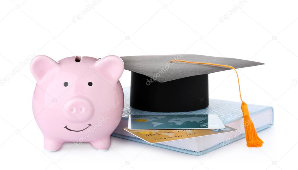 Graduation hat, credit cards, book and piggy bank isolated on white