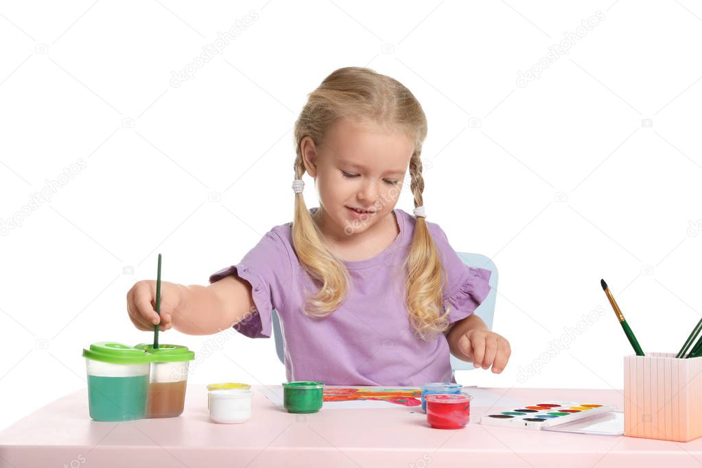 Cute child painting picture at table on white background