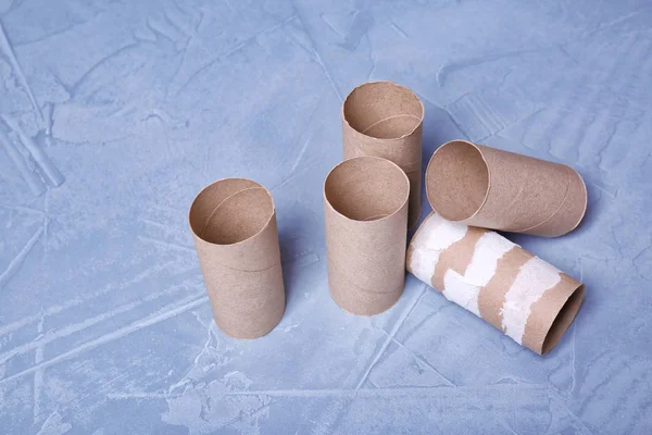 Empty toilet paper rolls on color background