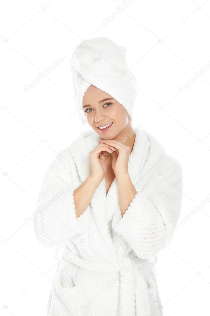 Portrait of young pretty woman in bathrobe with towel on white background