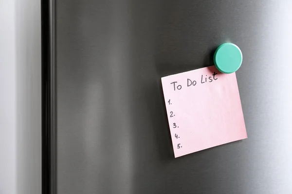 Note with words TO DO LIST on refrigerator door. Space for text