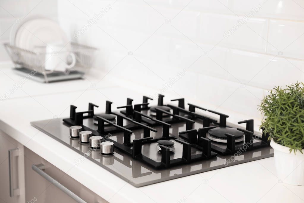 Modern built-in gas cooktop in light kitchen