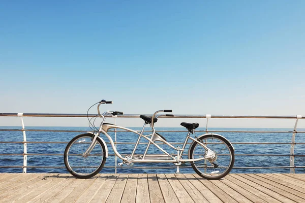 Tandem bike near sea on sunny day