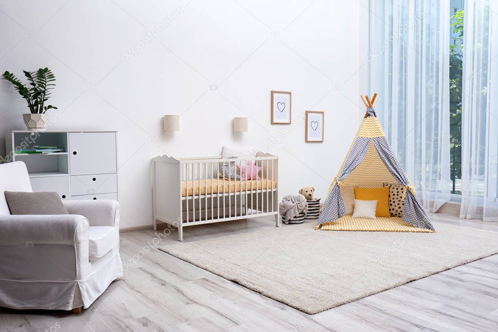 Cozy baby room interior with play tent and toys