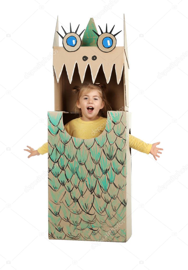 Little girl in cardboard costume of dinosaur on white background