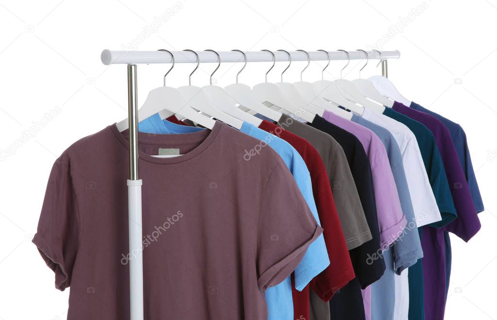 Men clothes hanging on wardrobe rack against white background