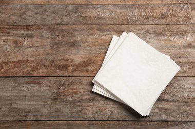 Clean napkins on wooden background, top view with space for text clipart
