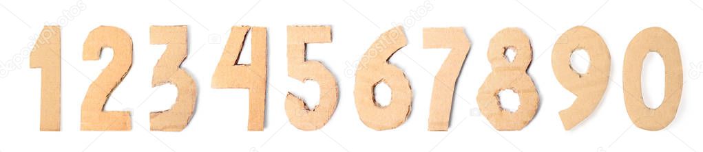 Set of cardboard numerals on white background, top view