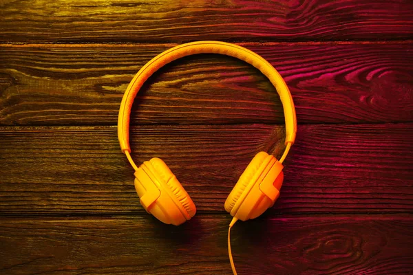 Stylish Modern Headphones Earmuffs Wooden Background Top View — Stock Photo, Image