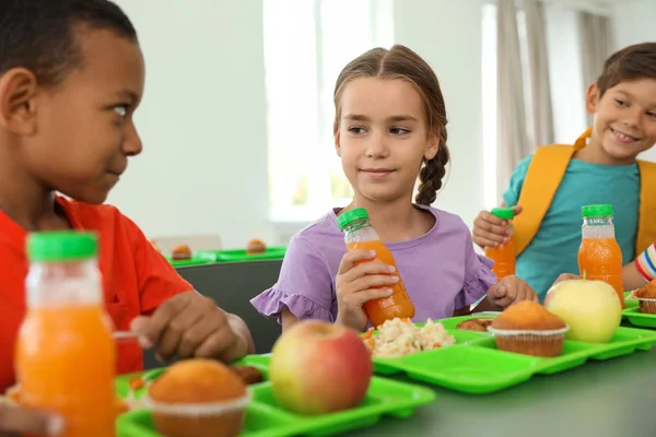 Happy children at table with healthy food in school canteen • wall stickers  unhealthy, tray, tasty