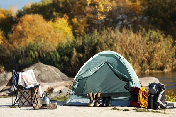 Set of equipment near camping tent outdoors