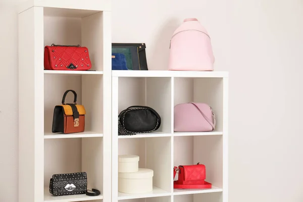 Wardrobe shelves with different stylish bags indoors. Idea for interior design
