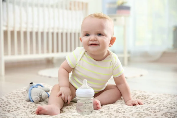 https://st4.depositphotos.com/16122460/23122/i/450/depositphotos_231225768-stock-photo-cute-baby-bottle-sitting-floor.jpg