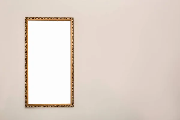 Frame with empty canvas on wall in modern art gallery. Mockup for design