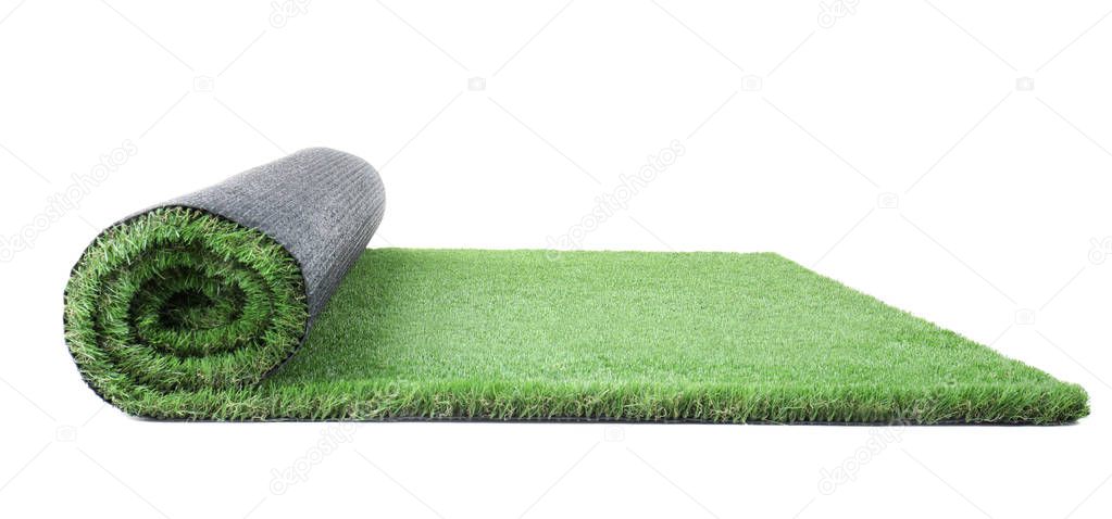 Rolled artificial grass carpet on white background. Exterior element