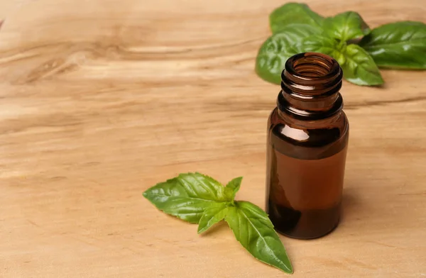 Bottle Basil Essential Oil Fresh Leaves Wooden Table Space Text — Stock Photo, Image