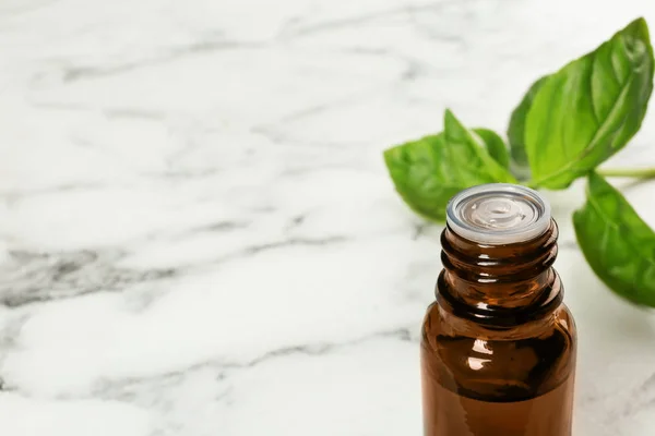 Bottle Basil Essential Oil Fresh Leaves Marble Table Space Text — Stock Photo, Image