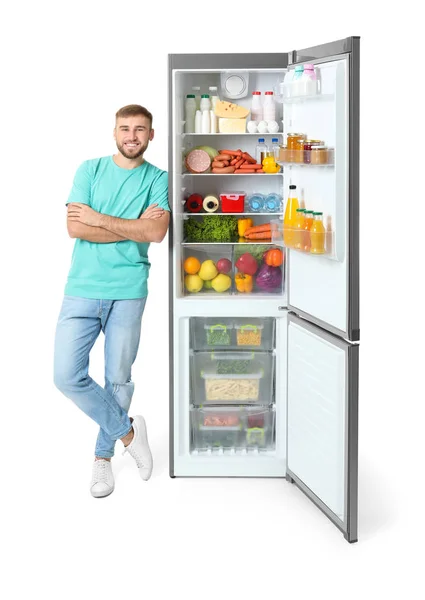 Молодой Человек Возле Открытого Холодильника Белом Фоне — стоковое фото