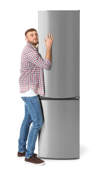 Молодой Человек Обнимает Закрытый Холодильник Белом Фоне — стоковое фото