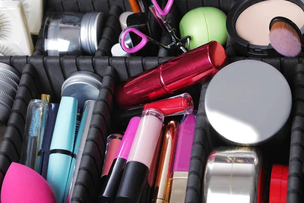 Stylish case with makeup products and beauty accessories, closeup