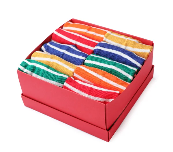 Box with cute child socks on white background