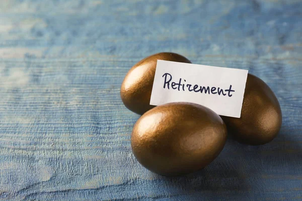 Golden Eggs Card Word Retirement Wooden Background Space Text Pension — Stock Photo, Image