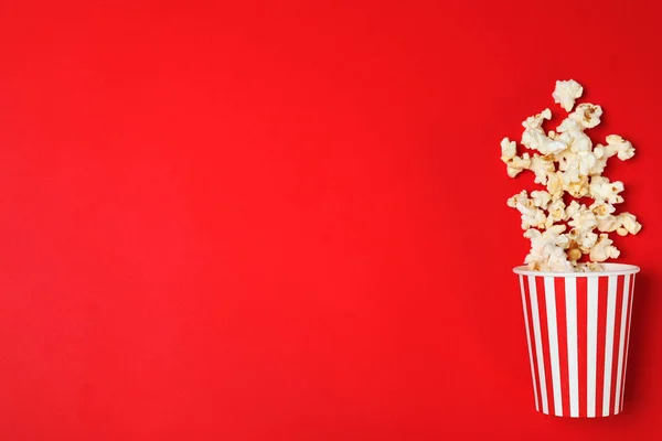 Umgekippter Pappbecher Mit Leckerem Popcorn Auf Farbigem Hintergrund Draufsicht Raum — Stockfoto