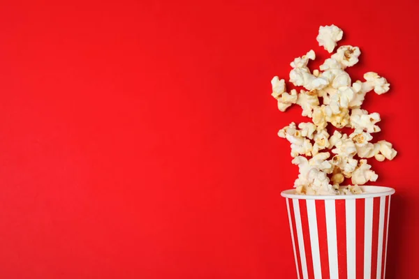 Umgekippter Pappbecher Mit Leckerem Popcorn Auf Farbigem Hintergrund Draufsicht Raum — Stockfoto